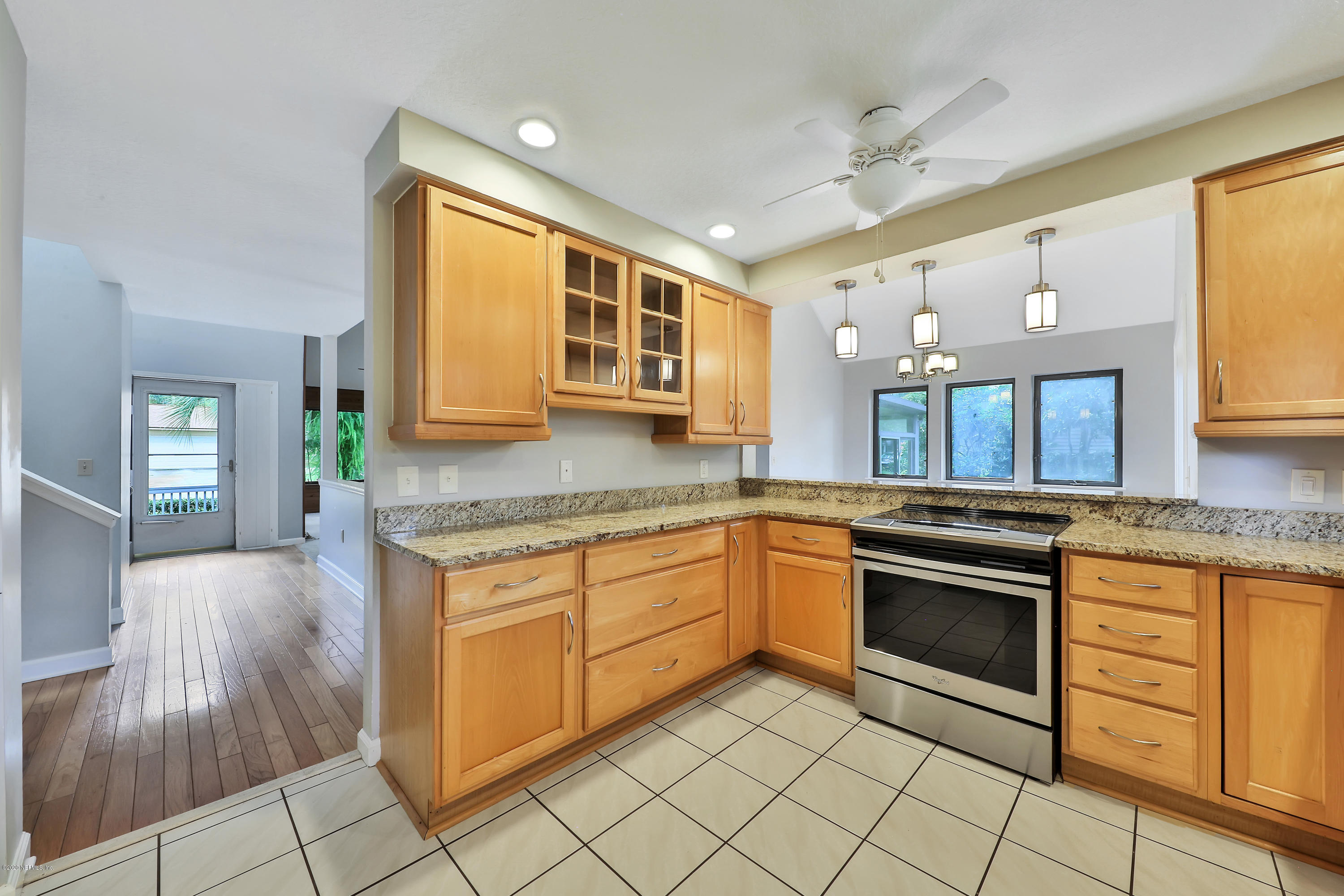 1350 Pinewood Road Jacksonville Beach, FL 32250 - Photo 17 of 45 a kitchen with stainless steel appliances granite countertop a stove a sink and a microwave