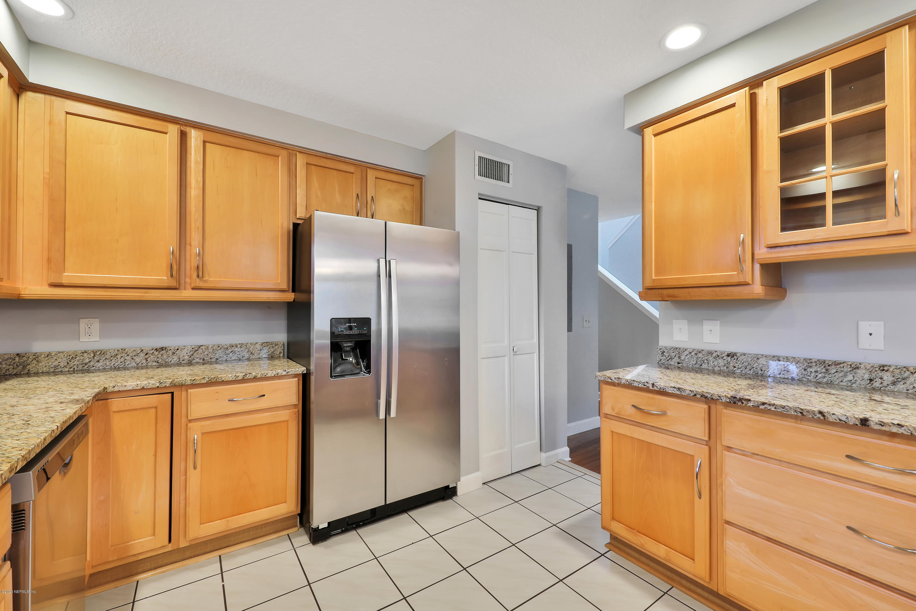 1350 Pinewood Road Jacksonville Beach, FL 32250 - Photo 18 of 45 a kitchen with stainless steel appliances granite countertop a refrigerator and cabinets