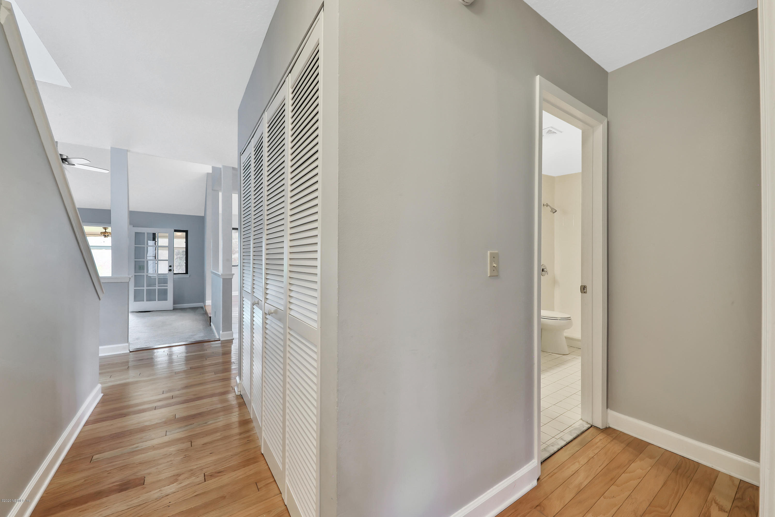 1350 Pinewood Road Jacksonville Beach, FL 32250 - Photo 24 of 45 a view of a hallway with wooden floor and staircase