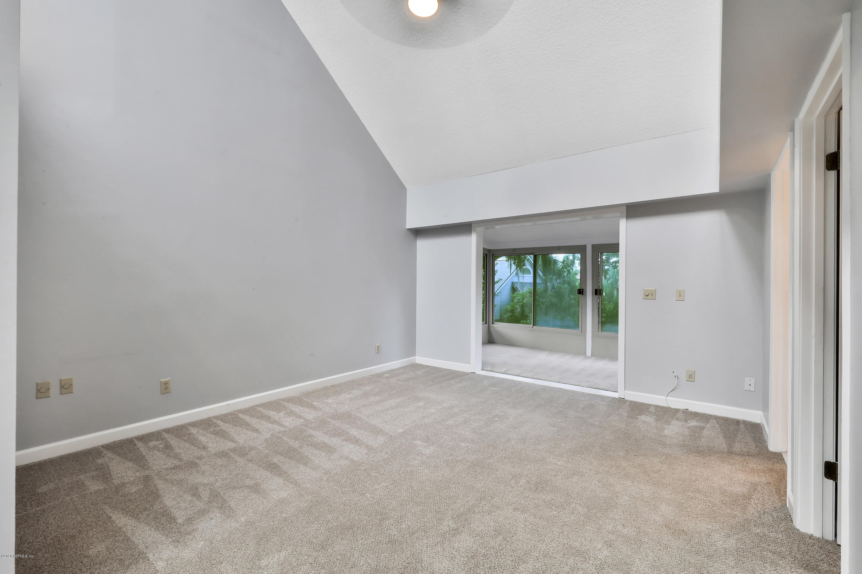 1350 Pinewood Road Jacksonville Beach, FL 32250 - Photo 29 of 45 a view of an empty room with wooden floor and a window