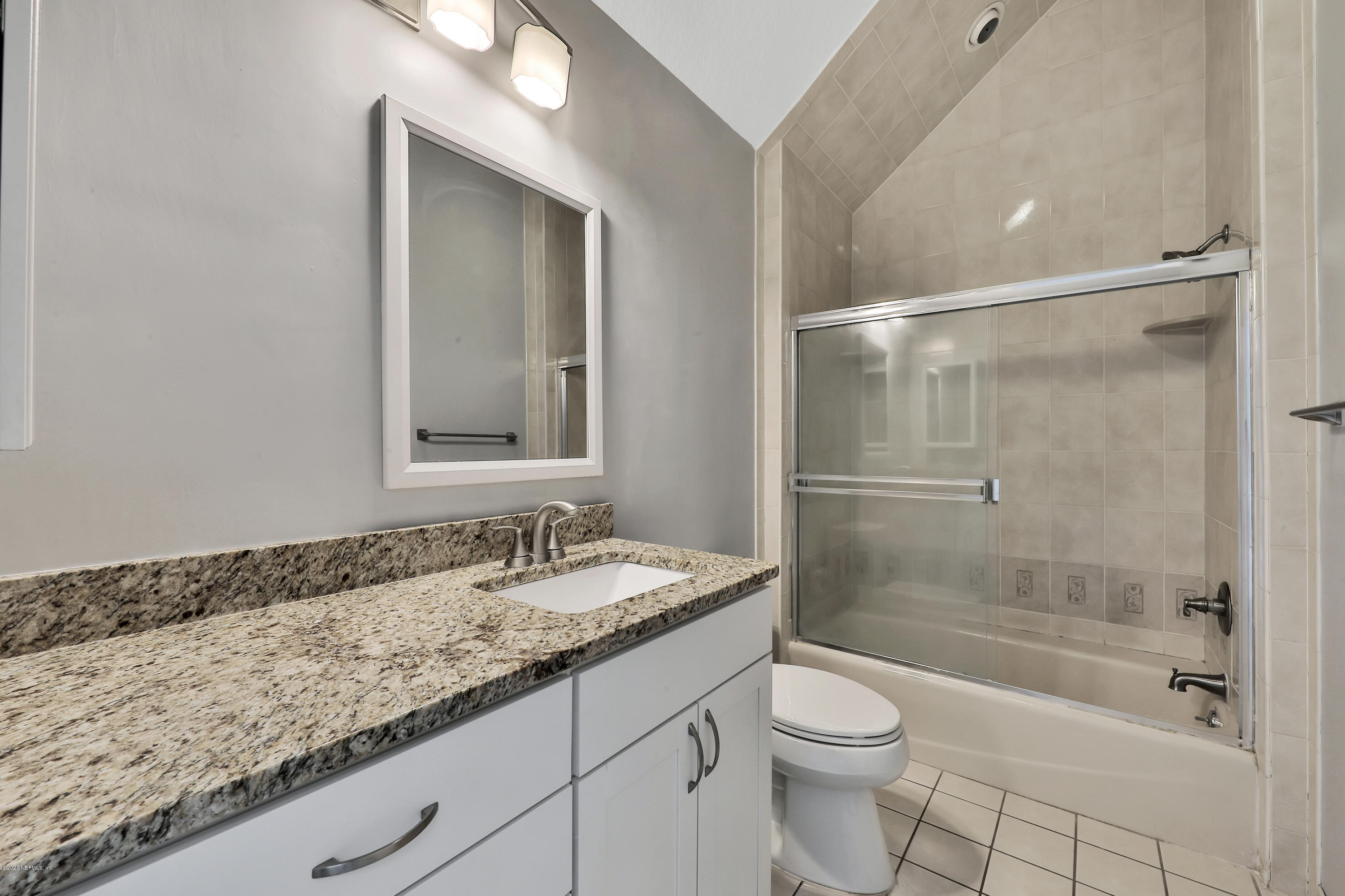 1350 Pinewood Road Jacksonville Beach, FL 32250 - Photo 31 of 45 a bathroom with a granite countertop sink a toilet and shower