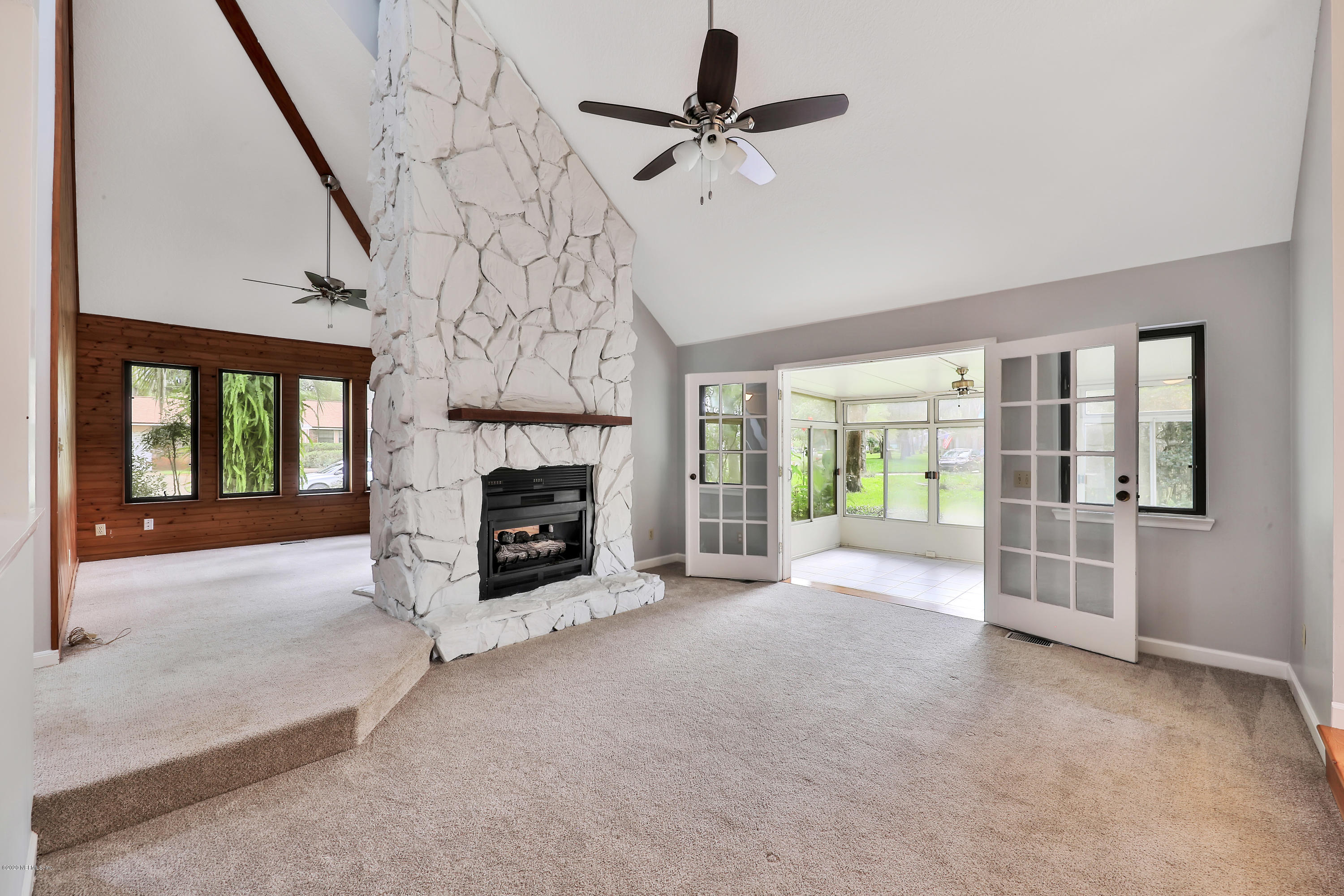 1350 Pinewood Road Jacksonville Beach, FL 32250 - Photo 4 of 45 a view of a livingroom with a fireplace and window