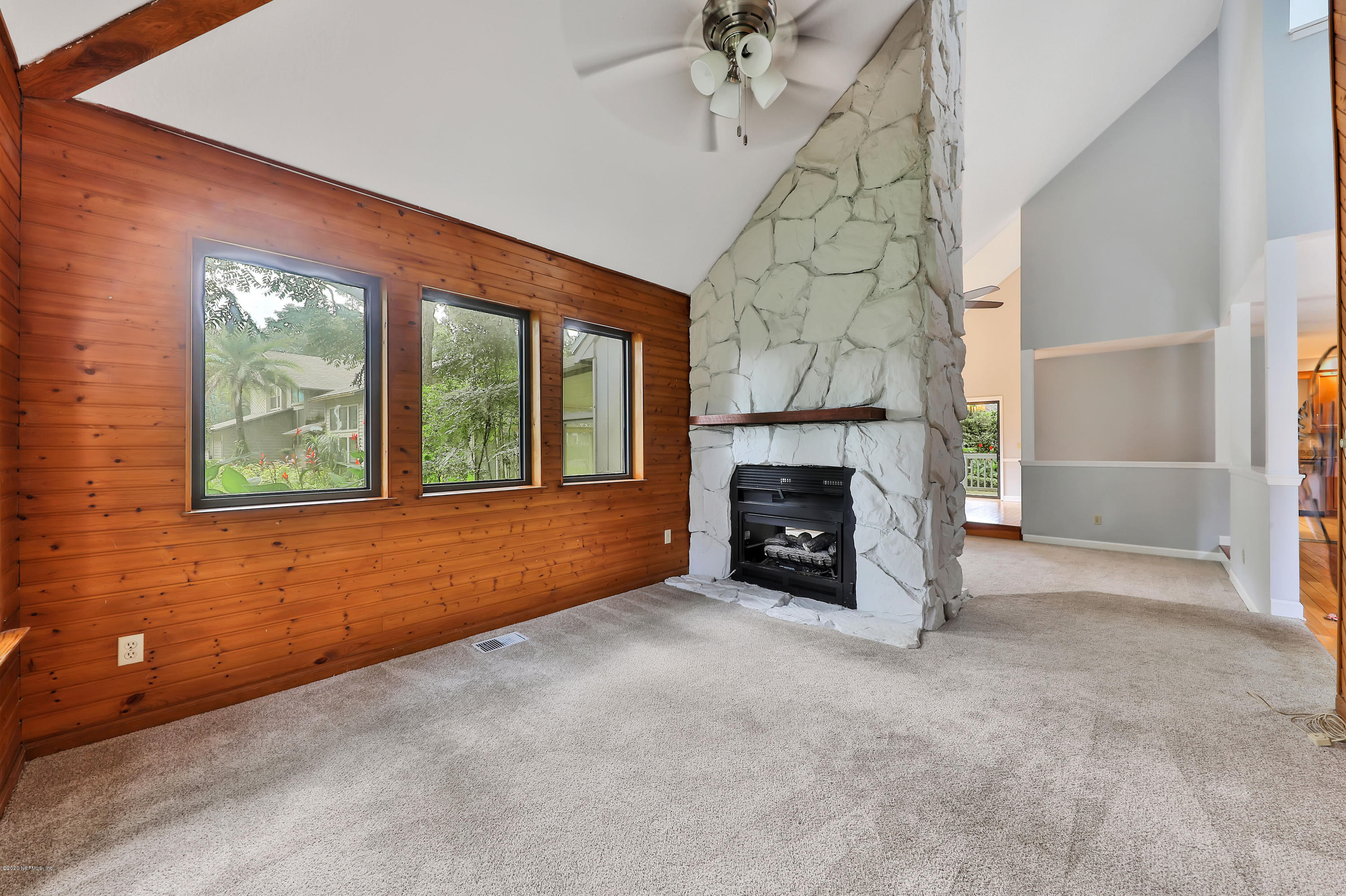 1350 Pinewood Road Jacksonville Beach, FL 32250 - Photo 5 of 45 an empty room with windows fire place and a fireplace