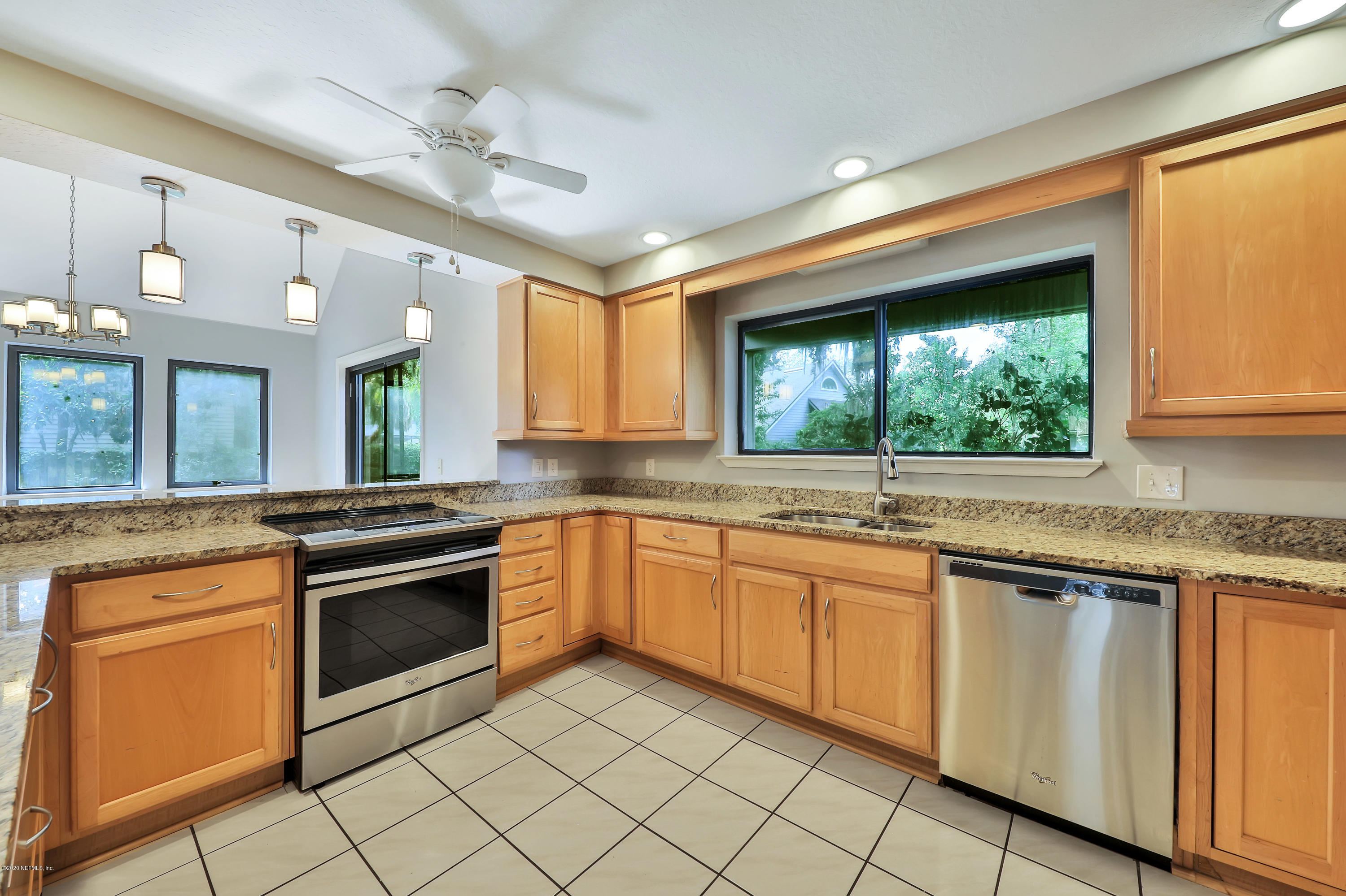 1350 Pinewood Road Jacksonville Beach, FL 32250 - Photo 6 of 45 a kitchen with granite countertop stainless steel appliances sink and cabinets