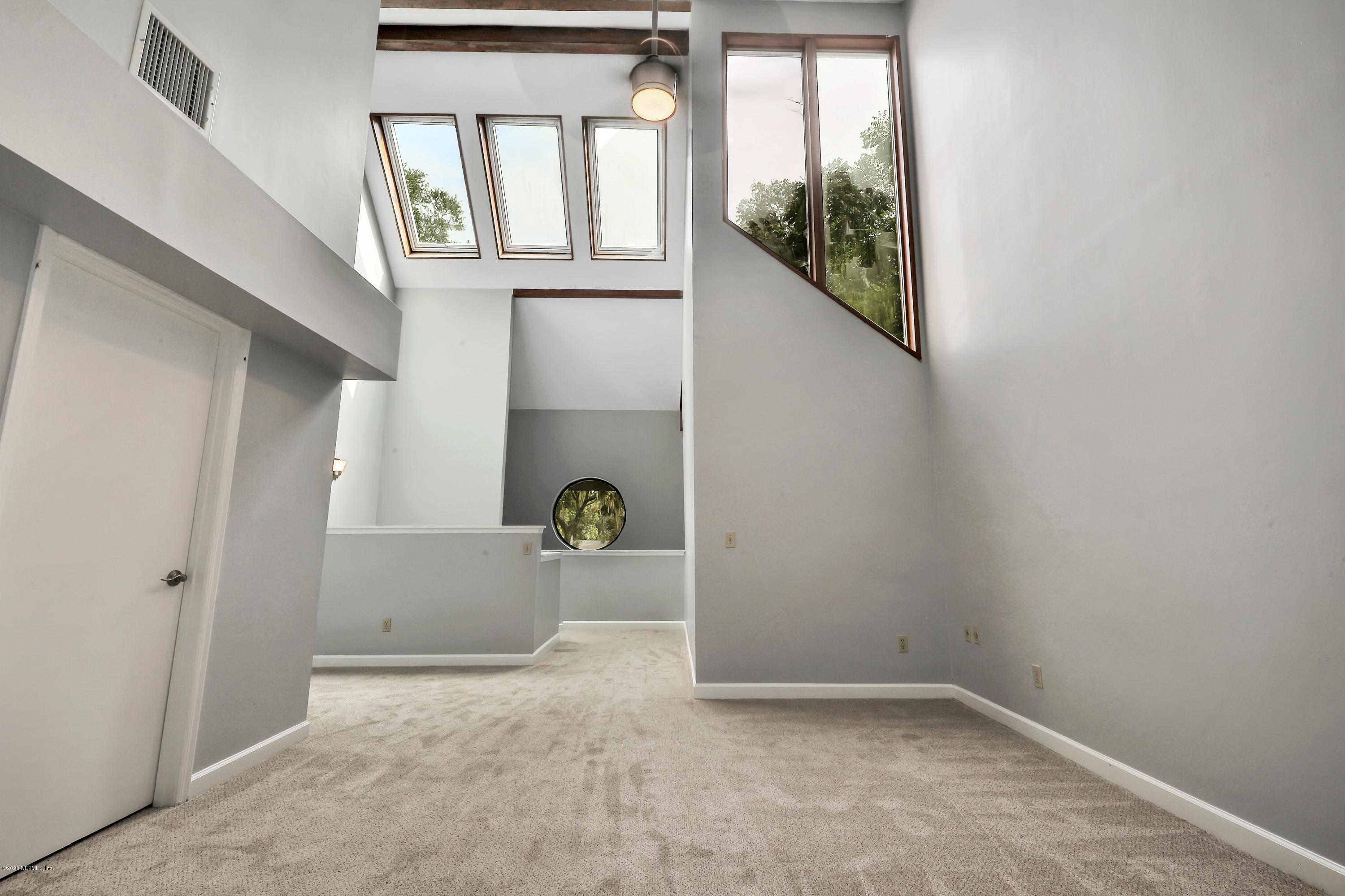 1350 Pinewood Road Jacksonville Beach, FL 32250 - Photo 9 of 45 a view of empty room with windows