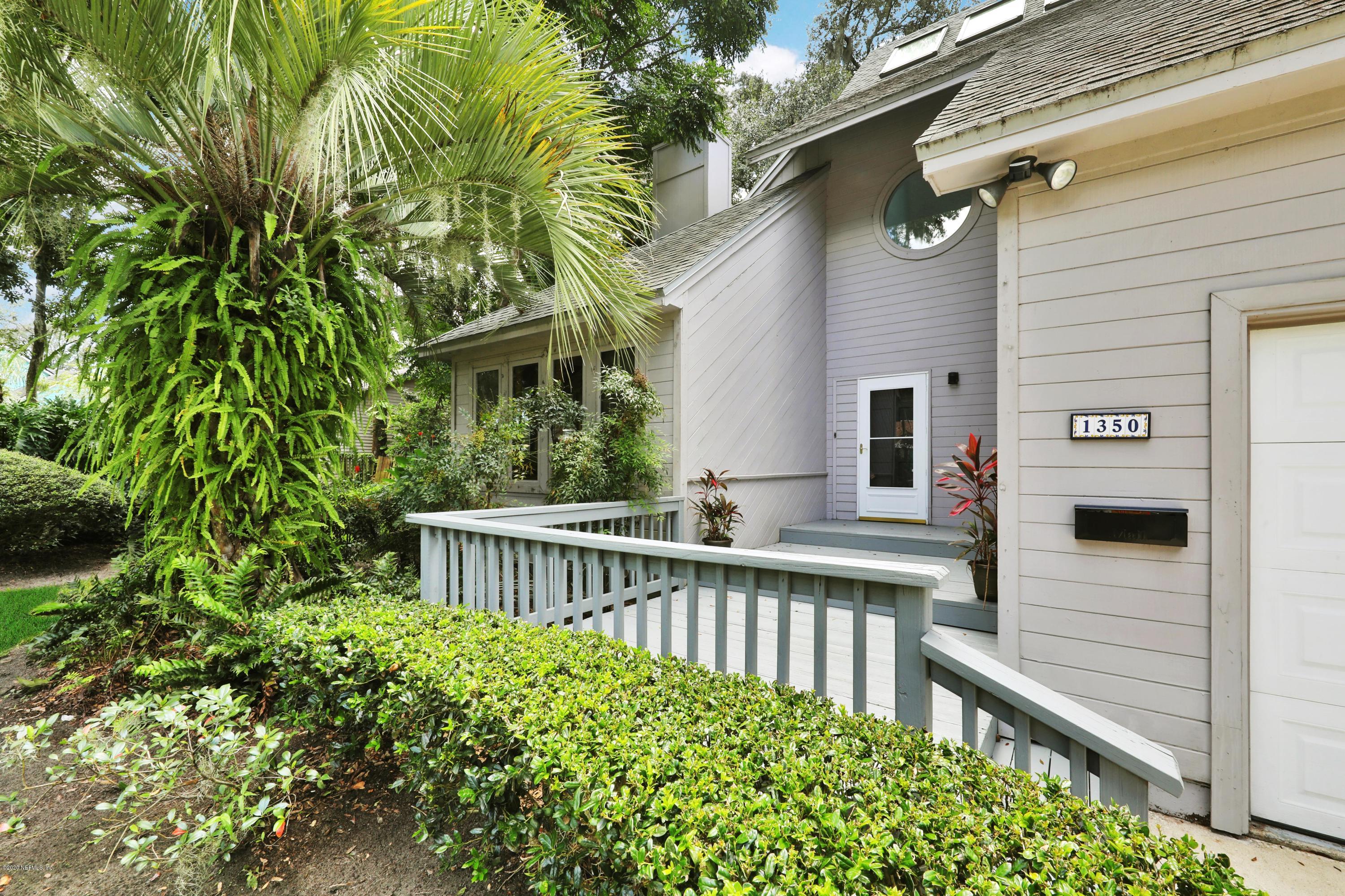 1350 Pinewood Road Jacksonville Beach, FL 32250 - Photo 10 of 45 a view of backyard with large trees and wooden fence