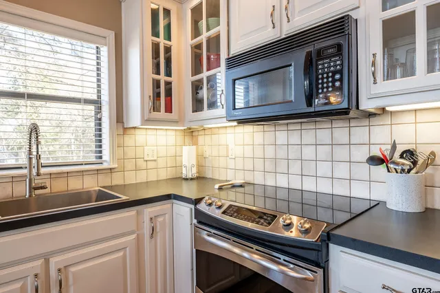 a kitchen with a sink and a stove next to a window