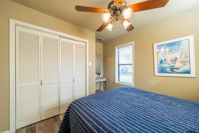 a bedroom with a bed and a chandelier