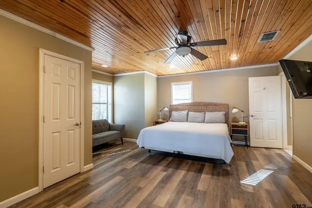 a bedroom with a bed and a flat screen tv