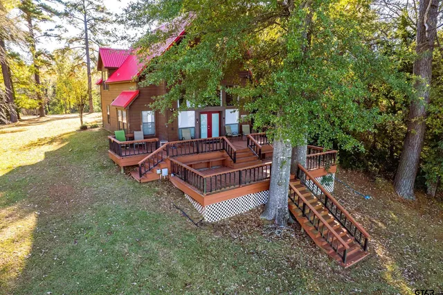 a view of a backyard with swimming pool