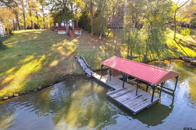 a view of sitting area with wooden floor and roof with city view