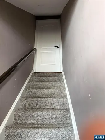 a view of staircase with white walls