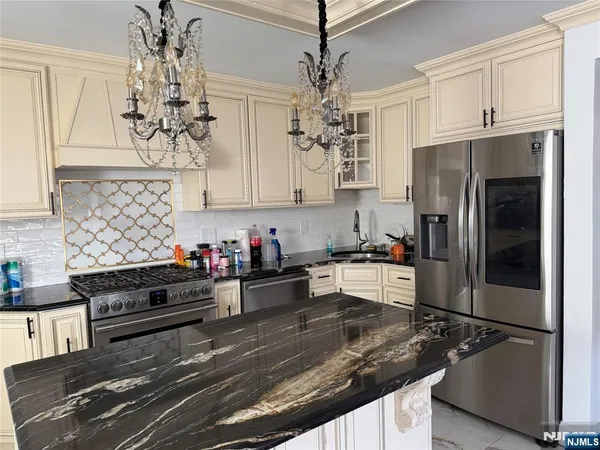 a kitchen with refrigerator and cabinets