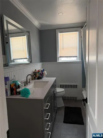 a bathroom with a sink a mirror and a window