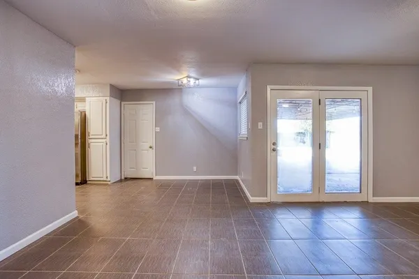 an empty room with windows and closet