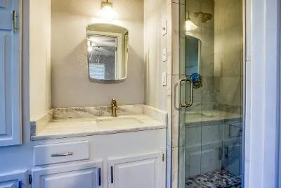 an empty room with floor to ceiling window and chandelier fan