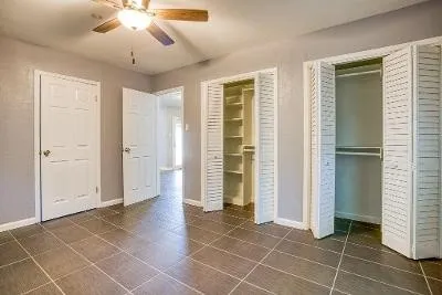 a bathroom with a granite countertop sink a mirror and a shower