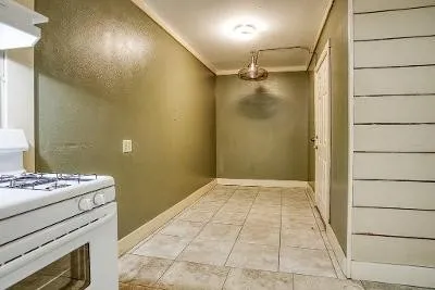 a view of an empty room with window and bathroom
