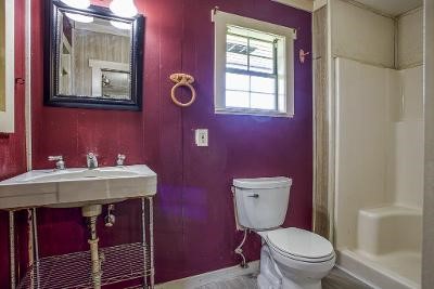 10733 Timbergrove Lane Corpus Christi, TX 78410 - Photo 35 of 40 a bathroom with a toilet a sink and mirror