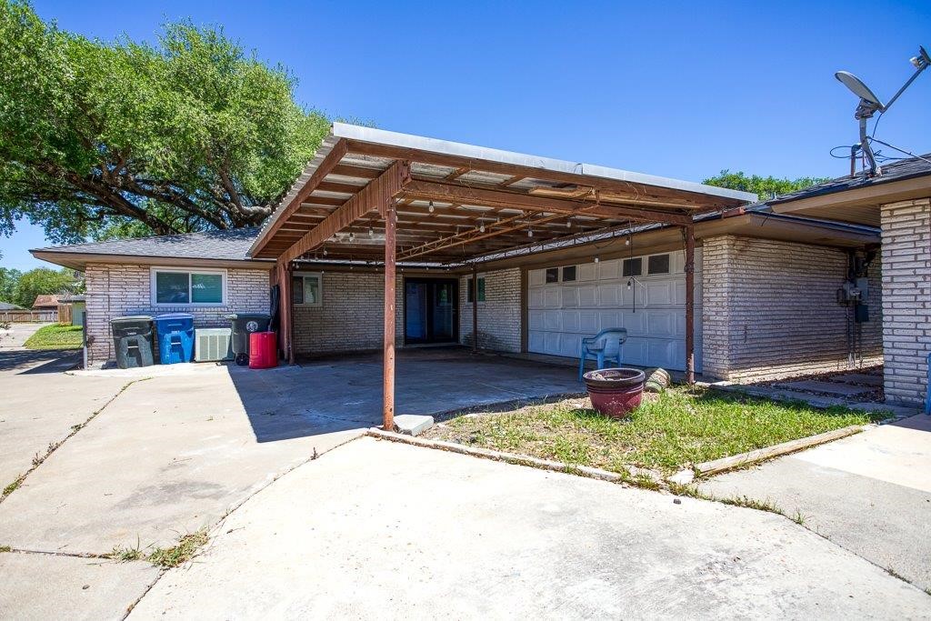 10733 Timbergrove Lane Corpus Christi, TX 78410 - Photo 37 of 40 a front view of a house with a yard