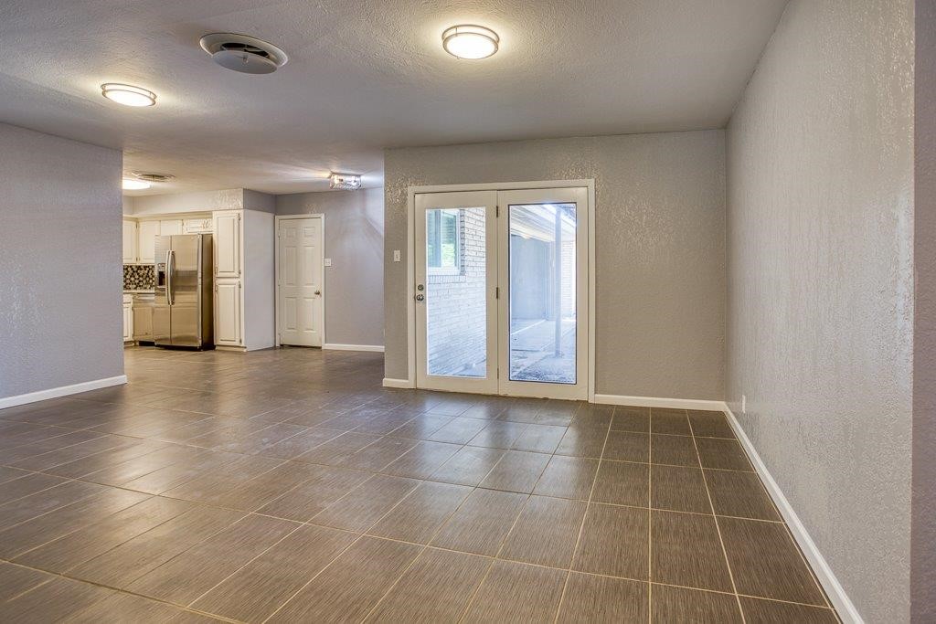 10733 Timbergrove Lane Corpus Christi, TX 78410 - Photo 5 of 40 a view of an empty room with glass door and chandelier fan