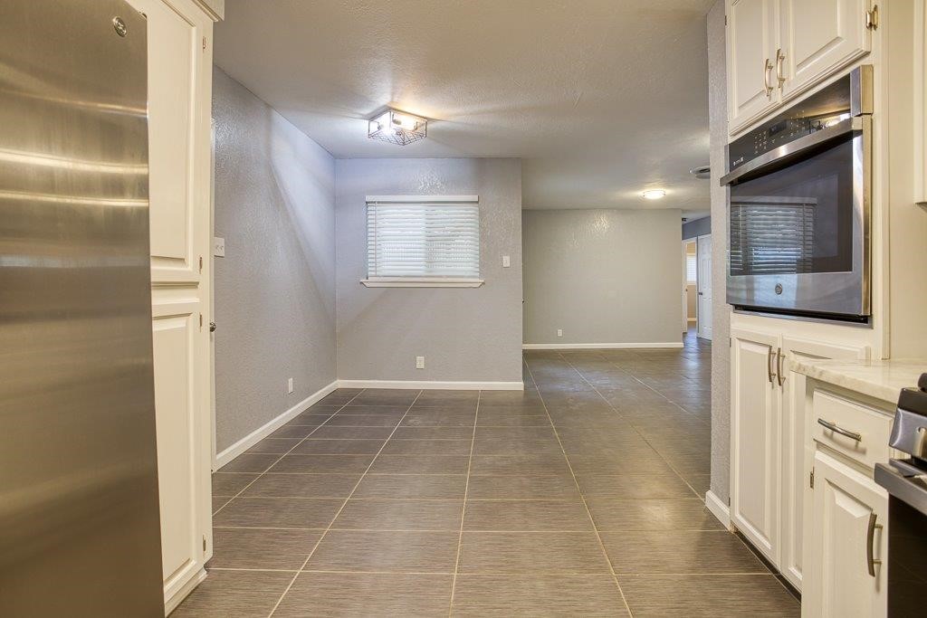 10733 Timbergrove Lane Corpus Christi, TX 78410 - Photo 10 of 40 a view of a kitchen with an empty space and a window