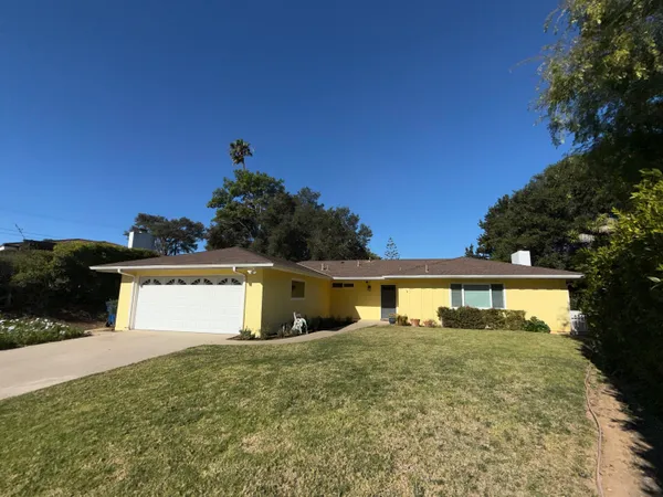 a view of a house with outdoor space and a yard