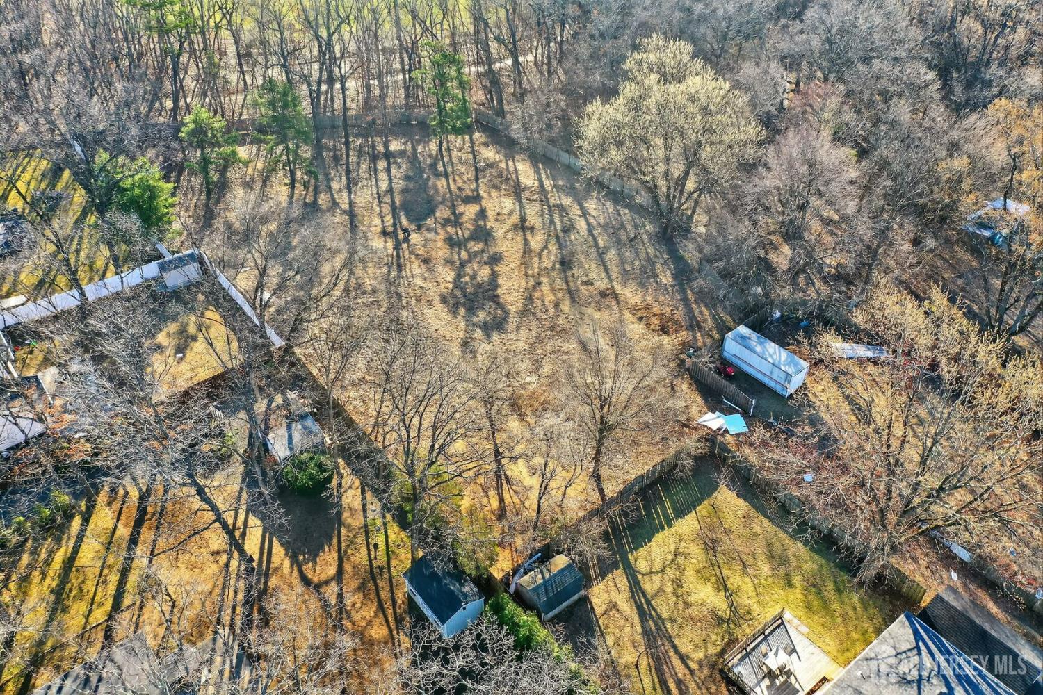 1212 Englishtown Road Iselin, NJ 08830 - Photo 6 of 7 a aerial view of a house with a yard and wooden fence