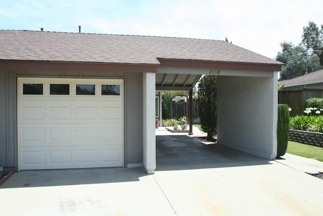 2118 Ridgeview Place Escondido, CA 92026 - Photo 1 of 25 Through the garage, carport or around the outside of the carport takes one to the front door. Please note the raised planter, green grass and fenced backyard.