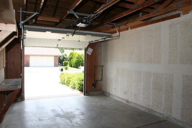 2118 Ridgeview Place Escondido, CA 92026 - Photo 23 of 25 Automatic roll-up garage door, work bench, some shelving and a laundry area with utility tub.