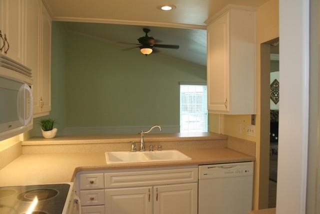 2118 Ridgeview Place Escondido, CA 92026 - Photo 10 of 25 Corian counters were added to the kitchen by the previous owner. In addition, the lighting was improved and cabinets painted. There is an eat-at counter behind the sink area.