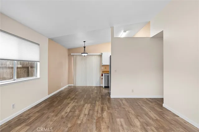 a view of a livingroom with wooden floor and a window