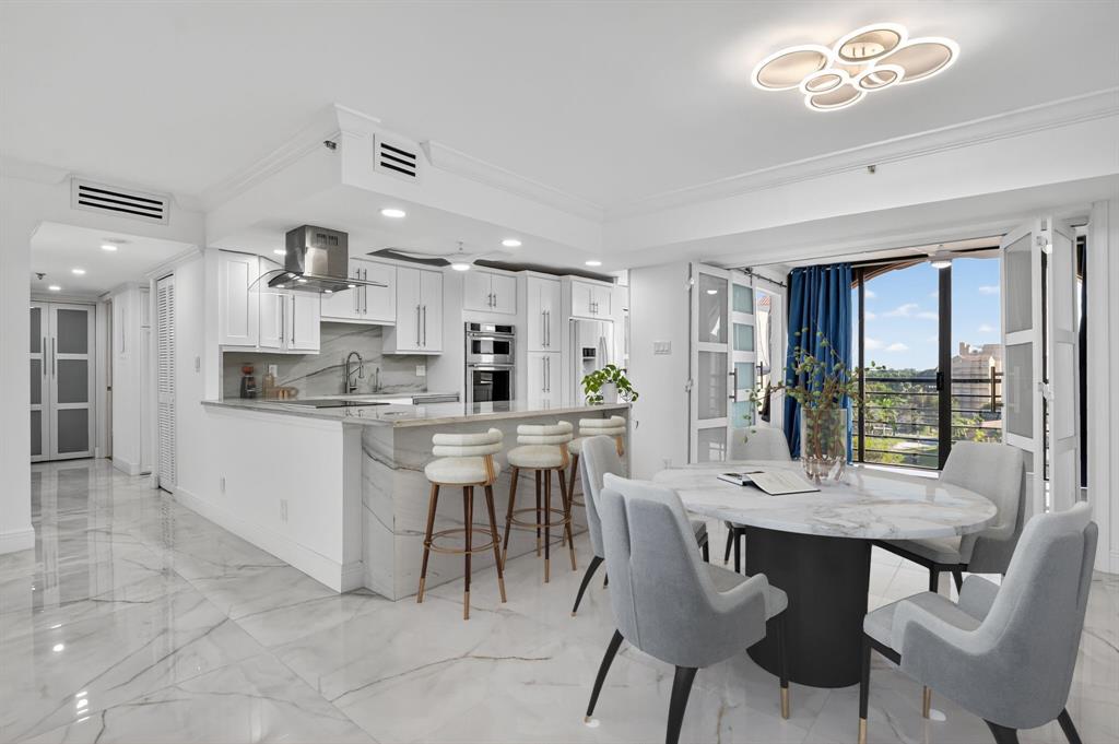 7145 Promenade Drive, Unit C702 Boca Raton, FL 33433 - Photo 23 of 82 a kitchen with a dining table chairs and large windows