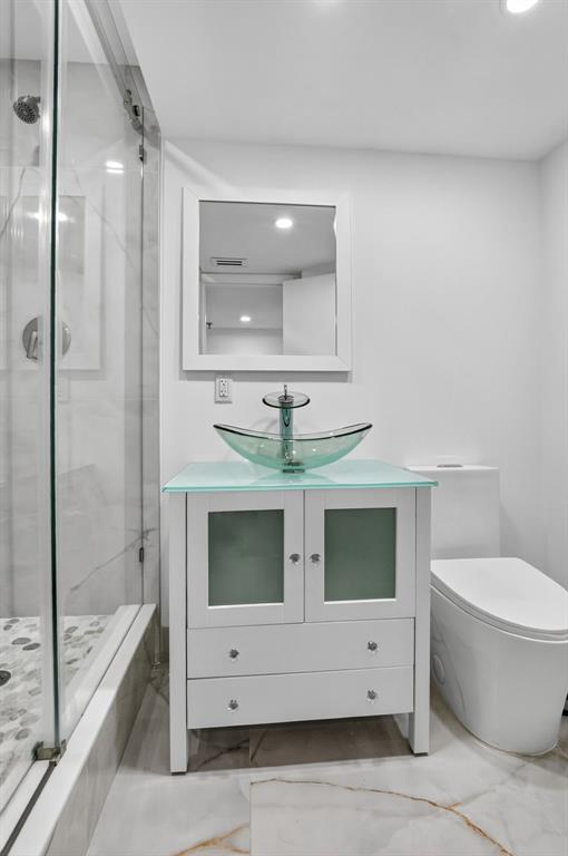 7145 Promenade Drive, Unit C702 Boca Raton, FL 33433 - Photo 38 of 82 a bathroom with a sink a toilet and bathtub