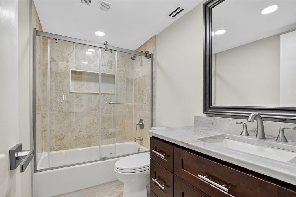 7145 Promenade Drive, Unit C702 Boca Raton, FL 33433 - Photo 43 of 82 a bathroom with a granite countertop sink toilet and shower