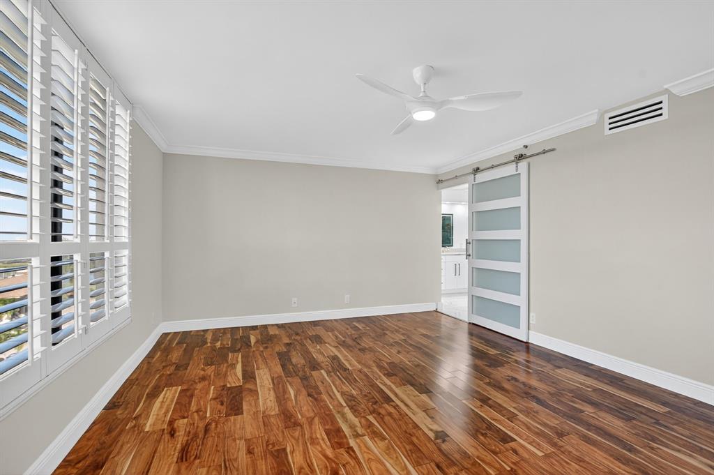 7145 Promenade Drive, Unit C702 Boca Raton, FL 33433 - Photo 46 of 82 a view of empty room with wooden floor and fan