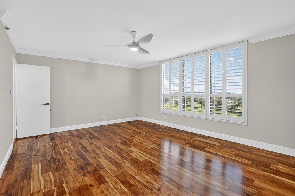 7145 Promenade Drive, Unit C702 Boca Raton, FL 33433 - Photo 47 of 82 a view of an empty room with wooden floor and a window