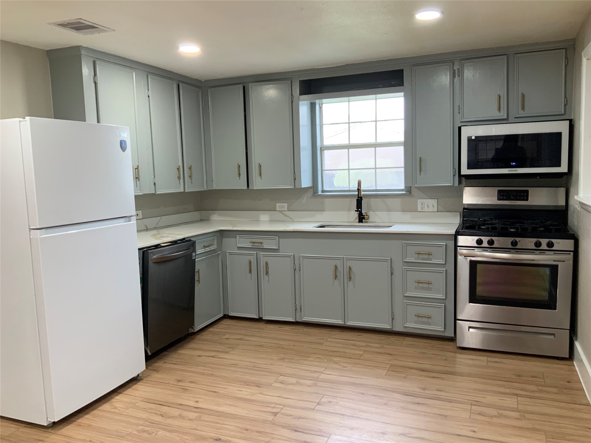 2415 Perry Street Baytown, TX 77521 - Photo 1 of 28 a kitchen with a sink stove and refrigerator