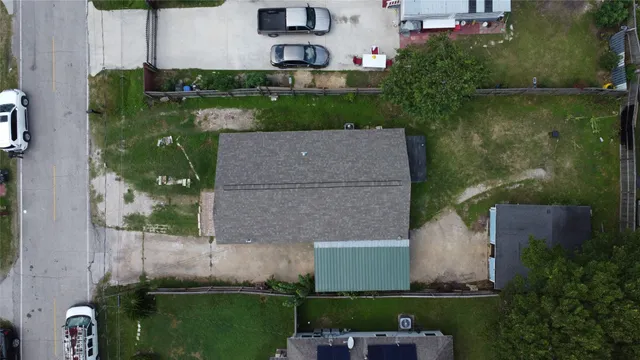 an aerial view of a house with a yard