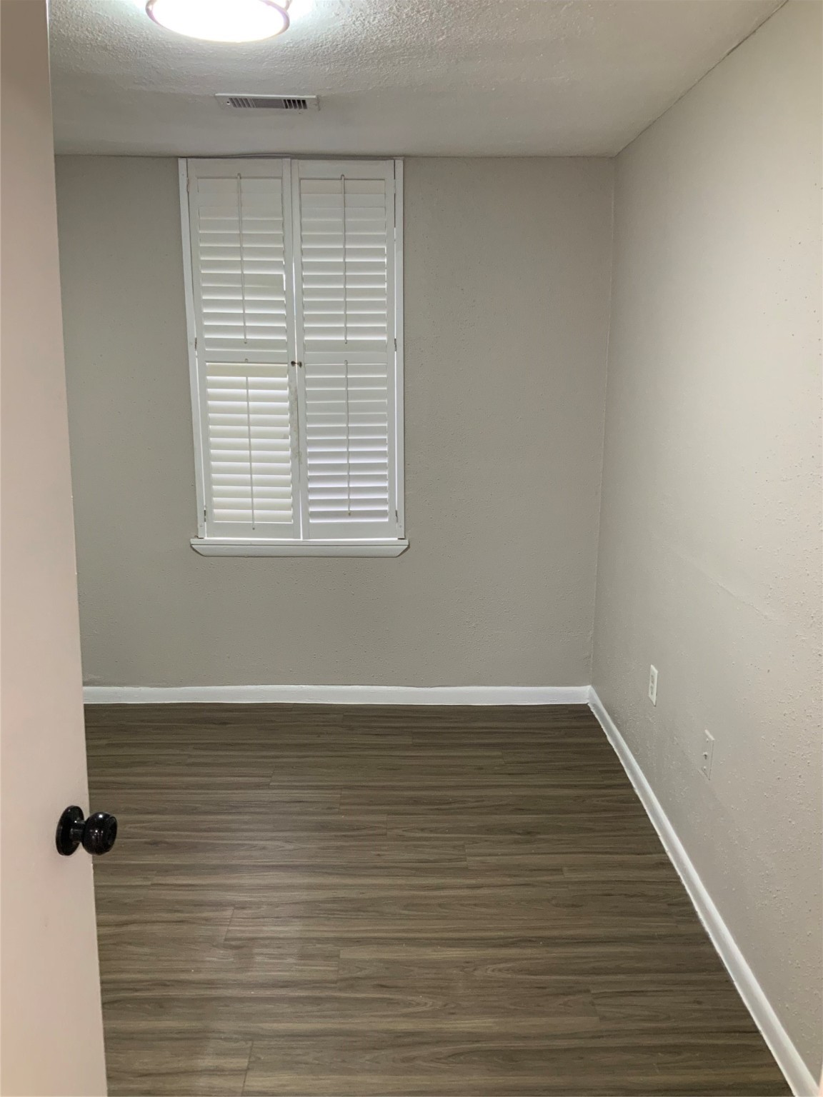 2415 Perry Street Baytown, TX 77521 - Photo 20 of 28 wooden floor in an empty room with a window