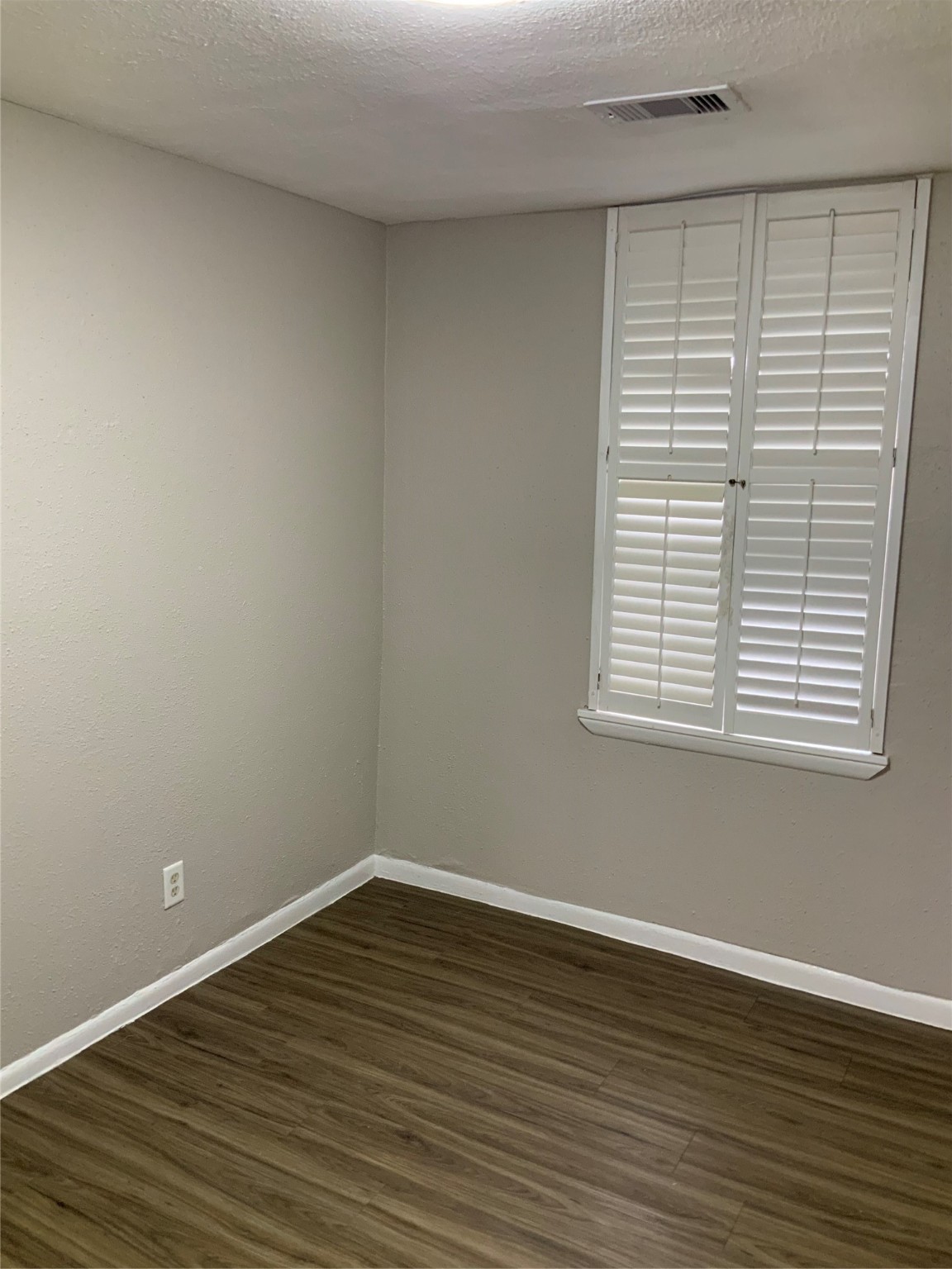 2415 Perry Street Baytown, TX 77521 - Photo 21 of 28 wooden floor in an empty room with a window