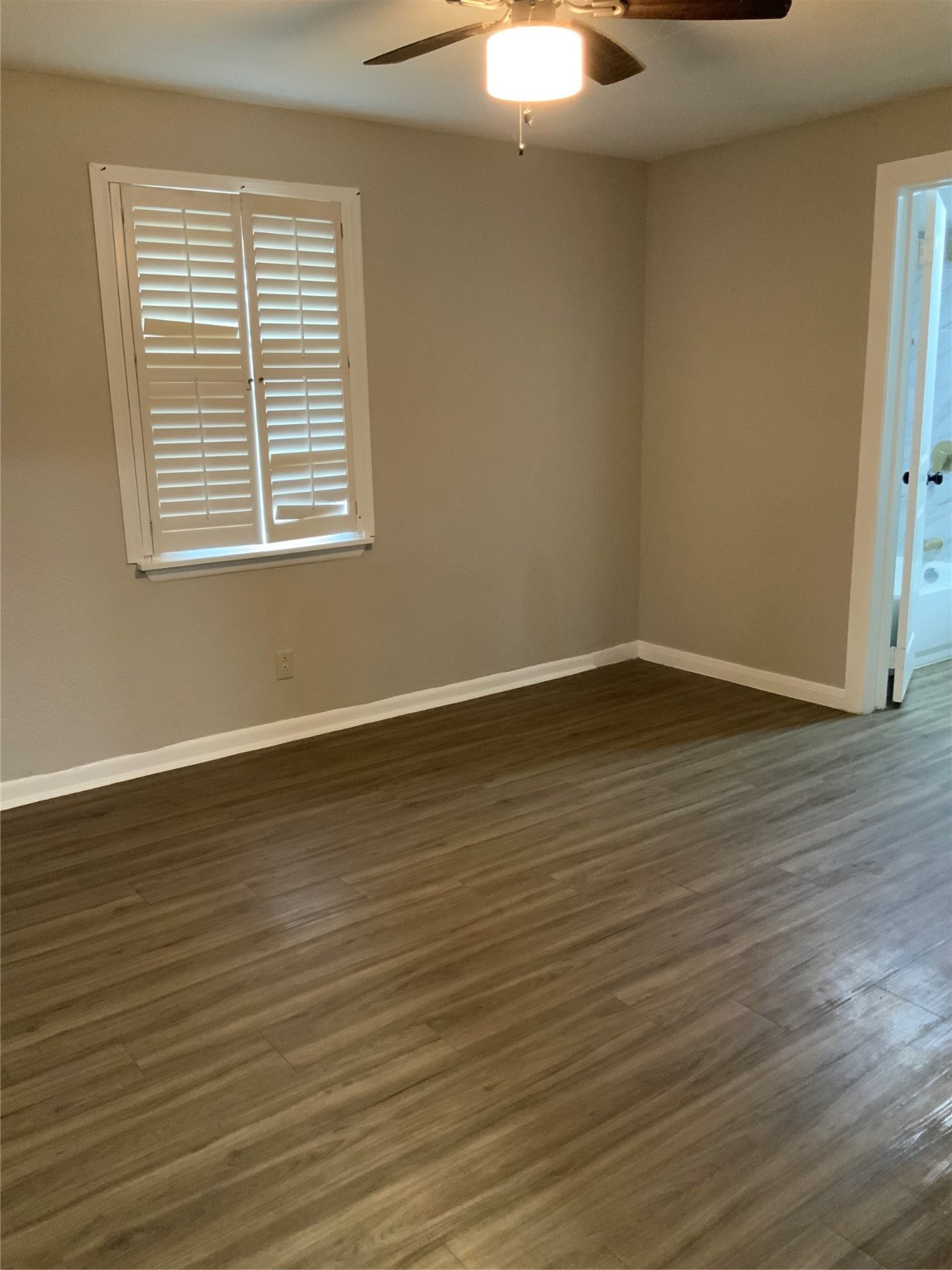 2415 Perry Street Baytown, TX 77521 - Photo 23 of 28 a view of an empty room with wooden floor and a window
