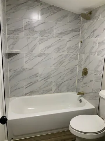 a bathroom with a toilet and bathtub