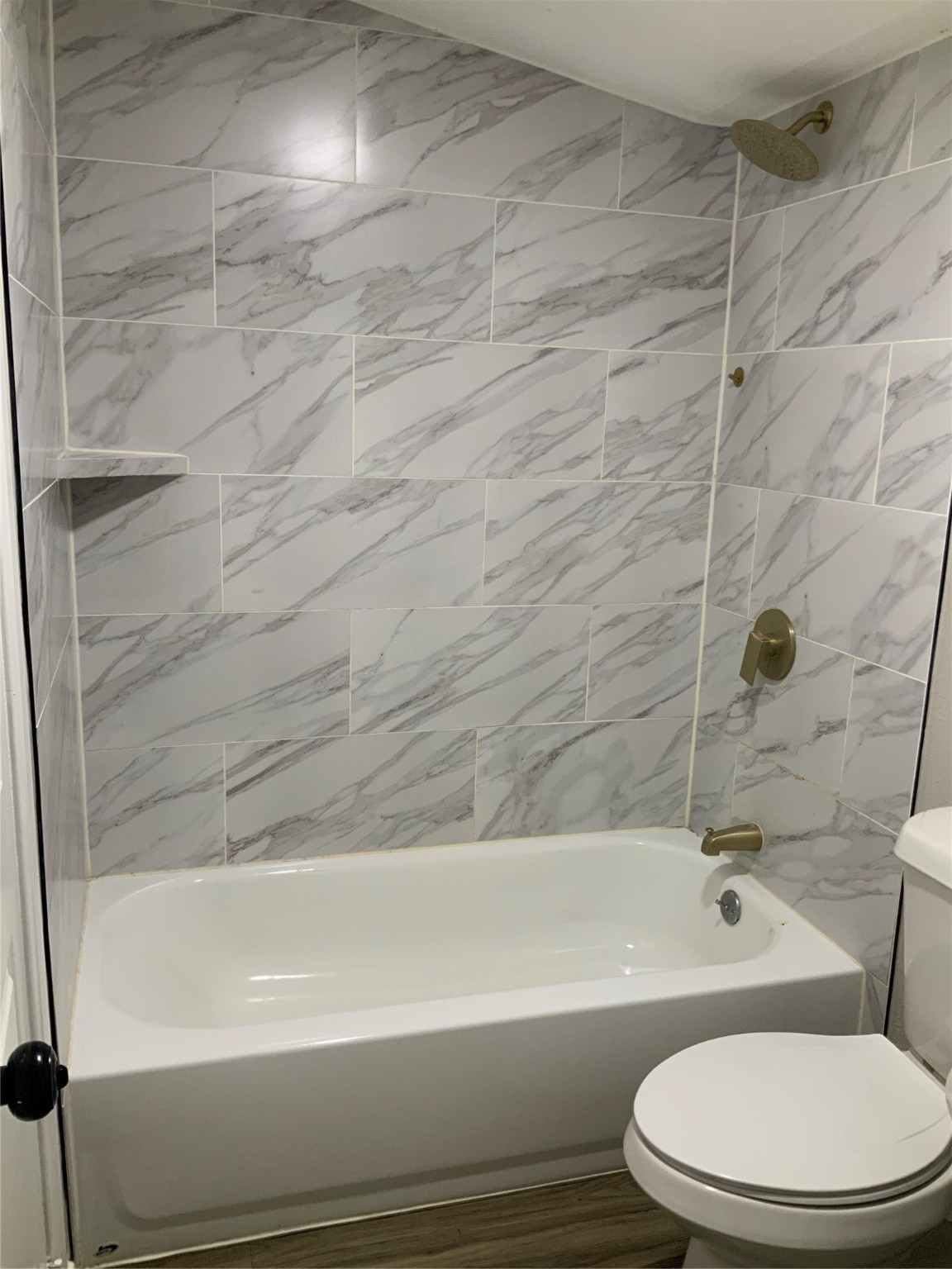 2415 Perry Street Baytown, TX 77521 - Photo 26 of 28 a bathroom with a toilet and bathtub