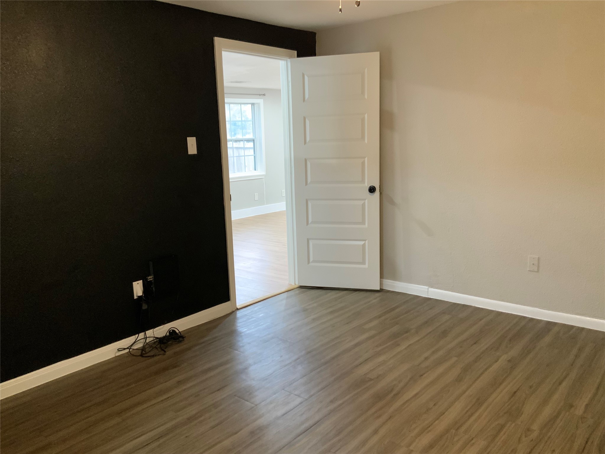 2415 Perry Street Baytown, TX 77521 - Photo 27 of 28 a view of an empty room with wooden floor and a window