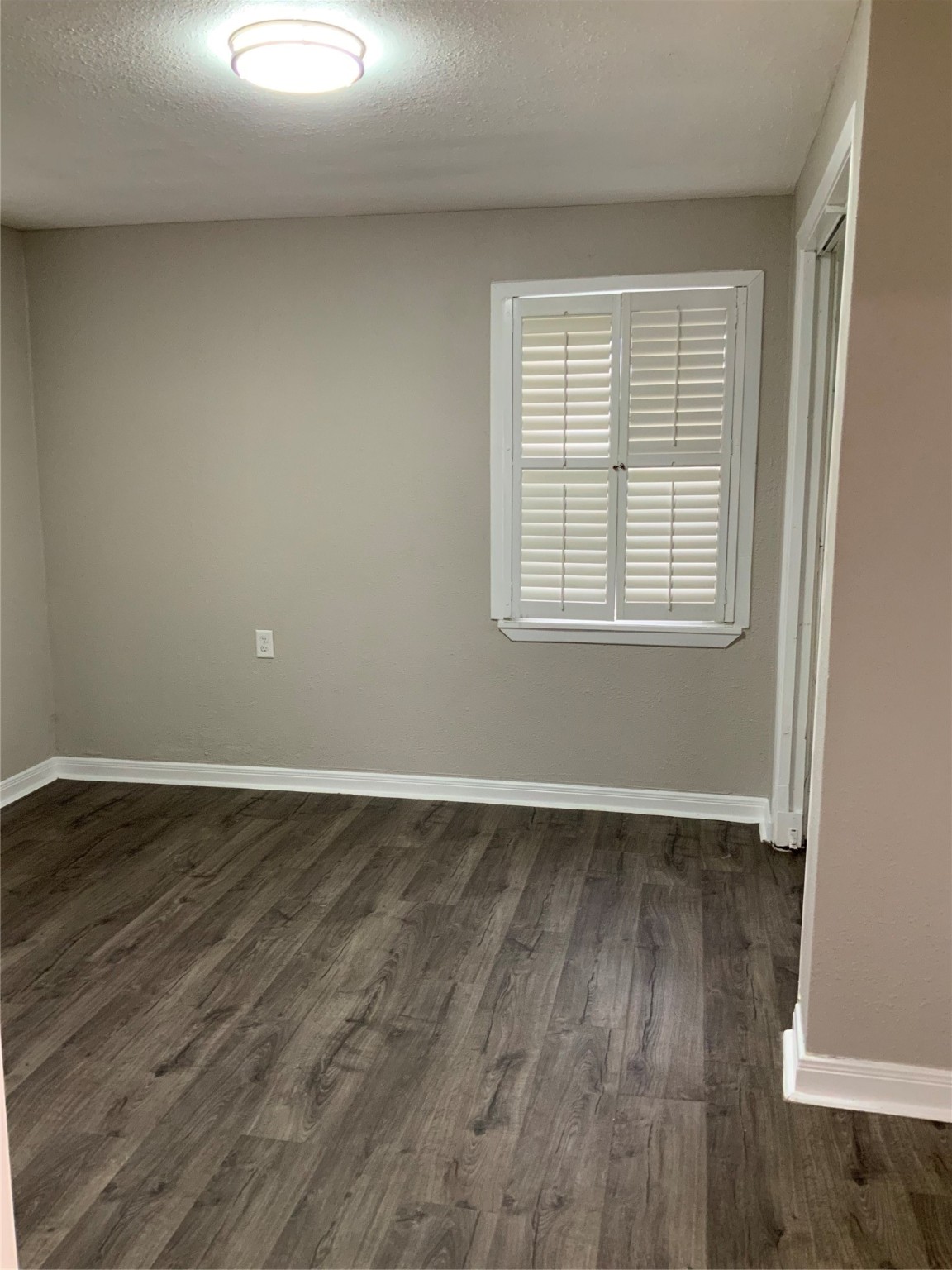 2415 Perry Street Baytown, TX 77521 - Photo 7 of 28 an empty room with wooden floor and windows