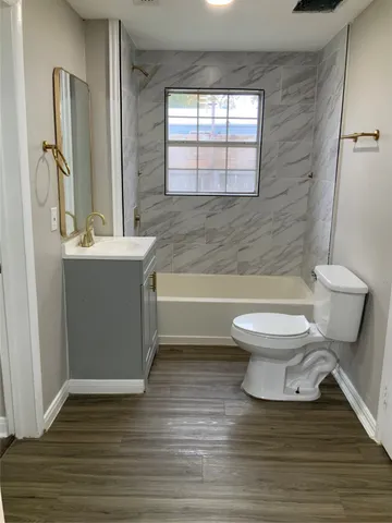 a bathroom with a toilet a sink and a bathtub