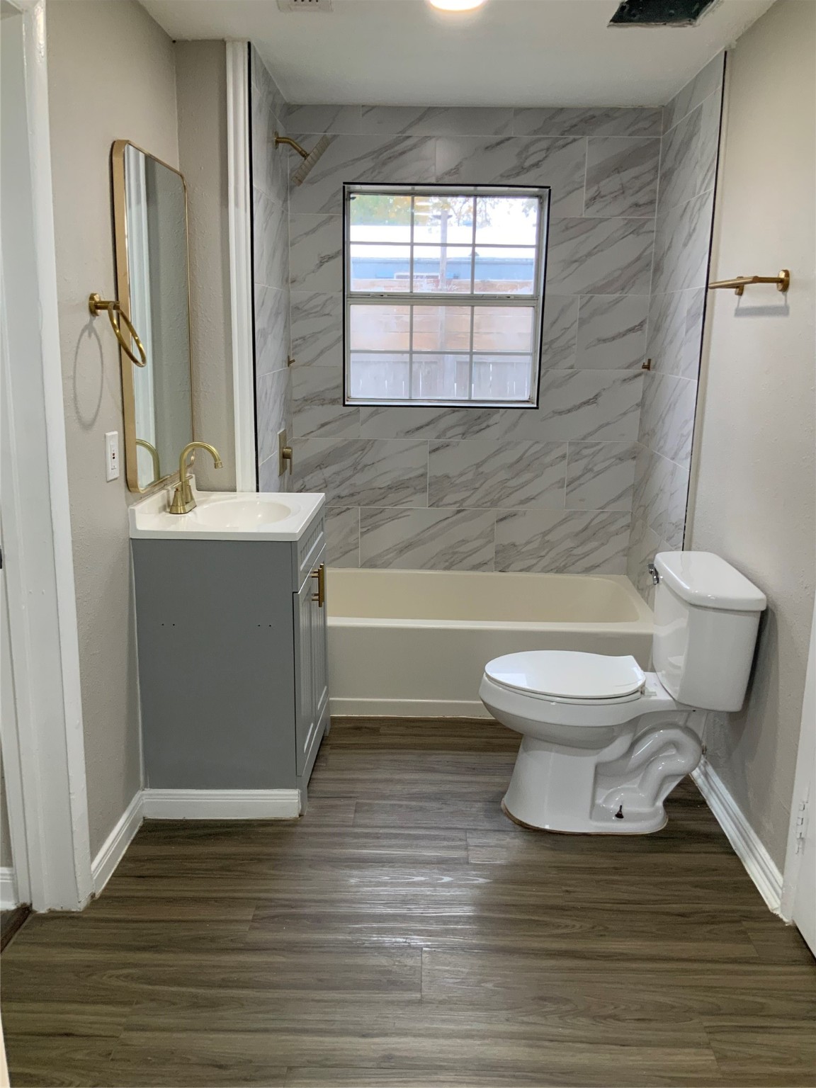 2415 Perry Street Baytown, TX 77521 - Photo 8 of 28 a bathroom with a toilet a sink and a bathtub