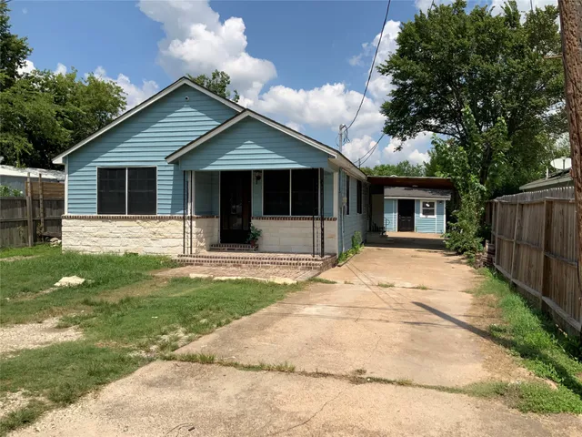 a front view of house with yard outdoor seating and barbeque oven