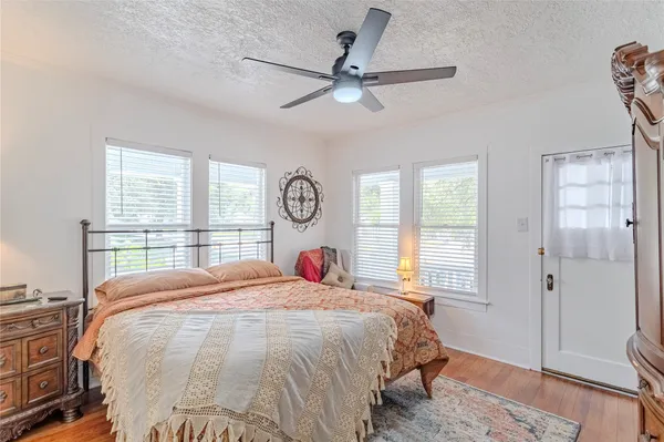 a bedroom with a large bed and a window
